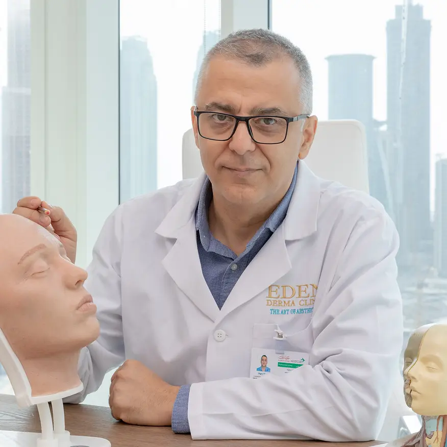 Dr. Qusai Shakhatreh, dermatologist at Nova Derma in Amman, seated in the clinic